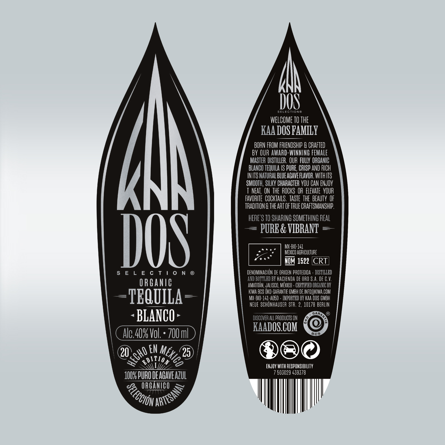 Close-up of the KA DOS Blanco bottle labels shown front and back, shaped like stylized agave leaves. The front label displays the KA DOS logo in silver on black, with product details like “Organic Tequila Blanco”, 40% vol., and “100% Puro de Agave Azul”. The back label highlights the brand story: a female master distiller, crisp agave flavor, and smooth character. Also visible: CRT and NOM 1522 certification, barcode, and sustainability icons.