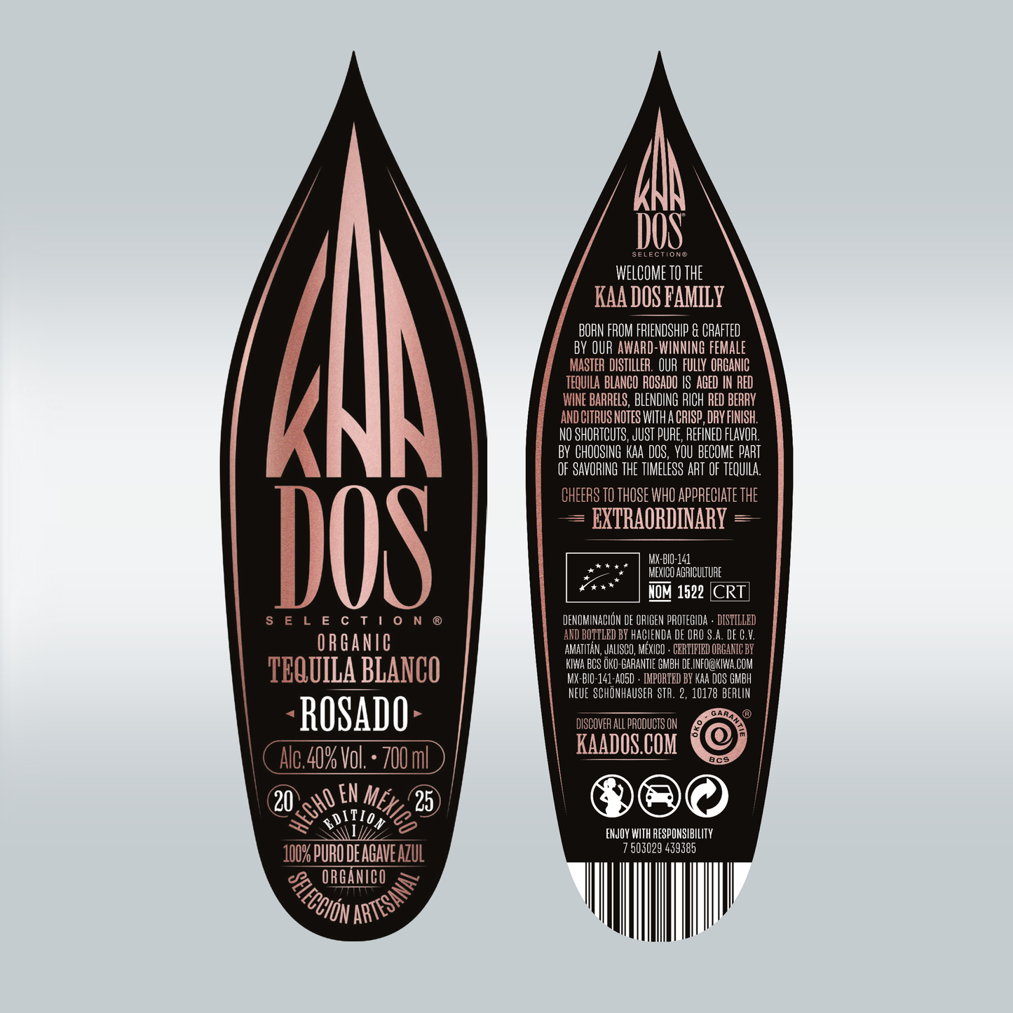 Close-up of KA DOS Rosado bottle labels, front and back, shaped like agave leaves. Front shows logo in rose-gold on black, with text: “Organic Tequila Blanco – Rosado”, 40% vol., and “100% Puro de Agave Azul”. Back highlights female master distiller, red wine barrel aging, and berry-citrus flavor. Includes CRT and NOM 1522 info, barcode, and icons.