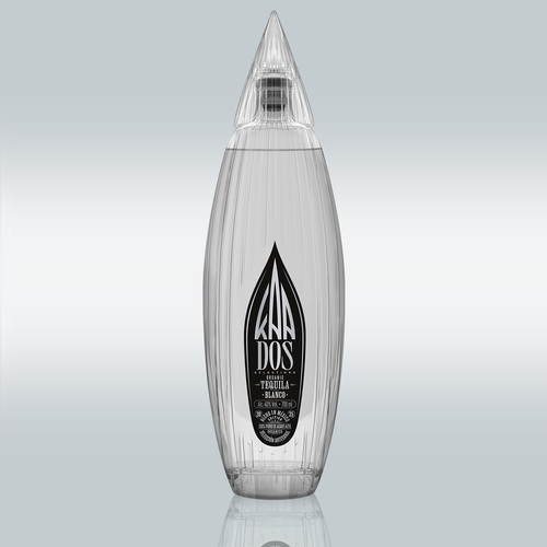 KA DOS Blanco bottle in sleek clear glass with vertical grooves and a sharp, faceted agave-leaf-shaped cap. Black-and-white front label features the KA DOS logo, “Organic Tequila Blanco”, 40% vol., 700 ml, and “100% Puro de Agave Azul”. Clean and modern design with artisanal detailing.